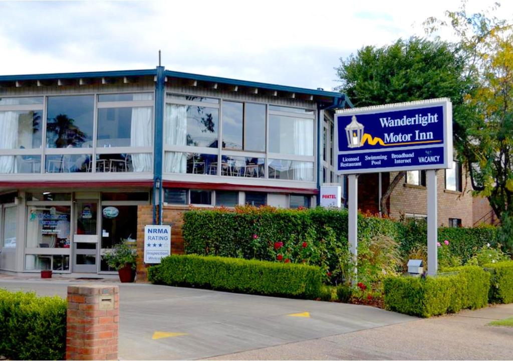 a sign for a new inn in front of a building at Wanderlight Motor Inn in Mudgee