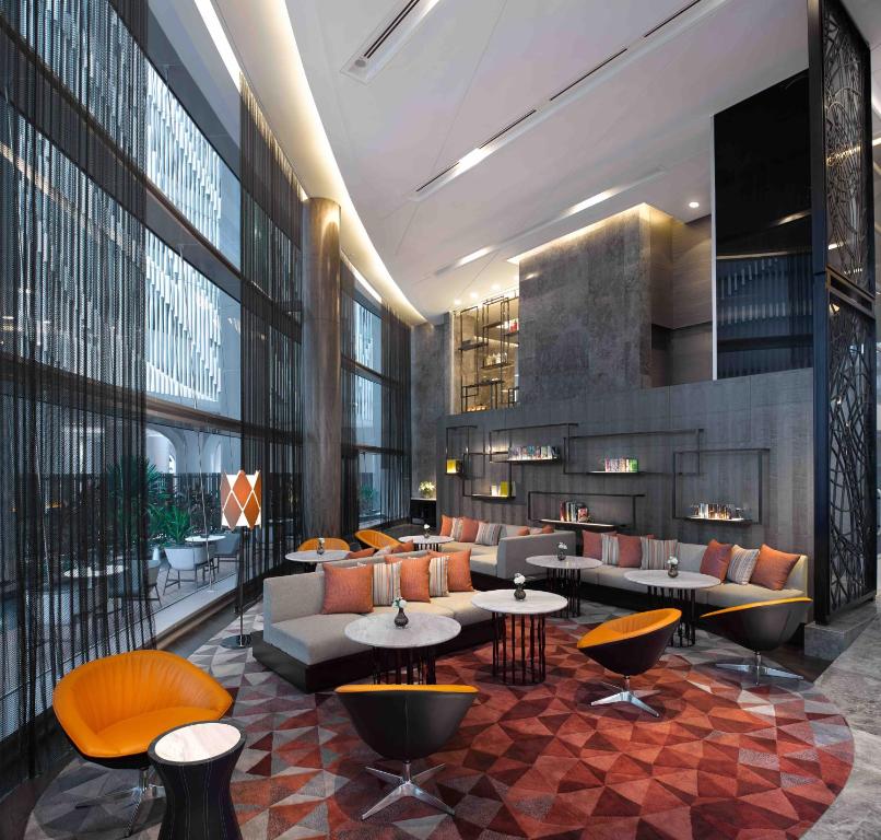 A long lobby lounge is arranged around sofas, armchairs and small round tables.