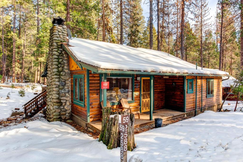 a log cabin in the woods in the snow at 59 Hansen Cabin in North Wawona
