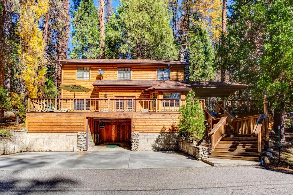 a large wooden house with a large deck at 7 Cedar Lodge in Wawona