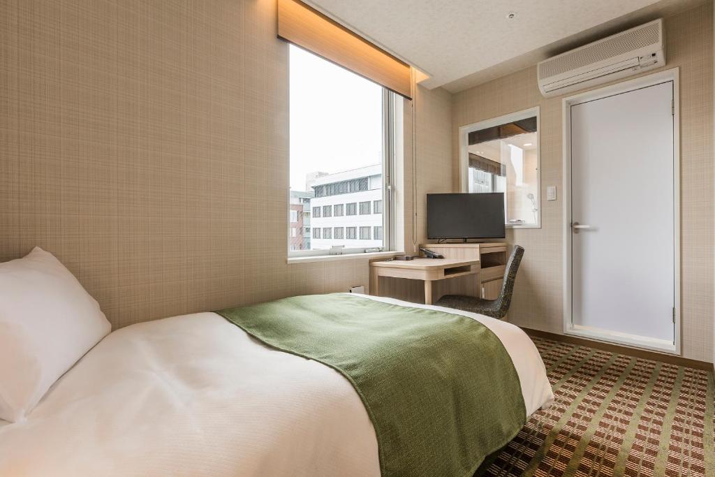 Postel nebo postele na pokoji v ubytování Garden Hotel Shizuoka