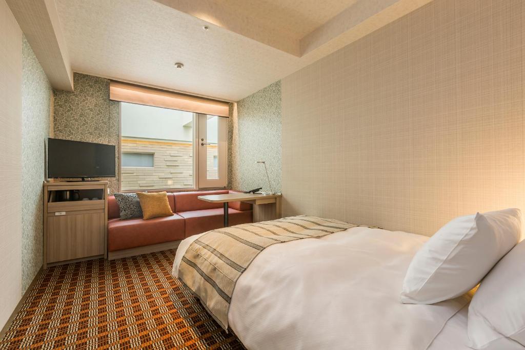 Postel nebo postele na pokoji v ubytování Garden Hotel Shizuoka