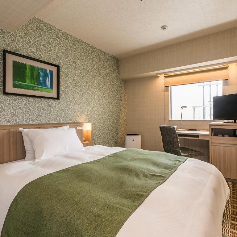 Postel nebo postele na pokoji v ubytování Garden Hotel Shizuoka