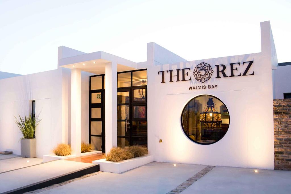 a building with a sign that reads the rez watches inn at The Rez Guesthouse in Walvis Bay