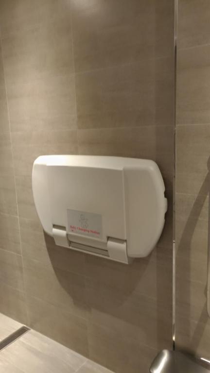 a paper towel dispenser on a wall in a bathroom at CityInn Hotel Plus- Fuxing North Road Branch in Taipei