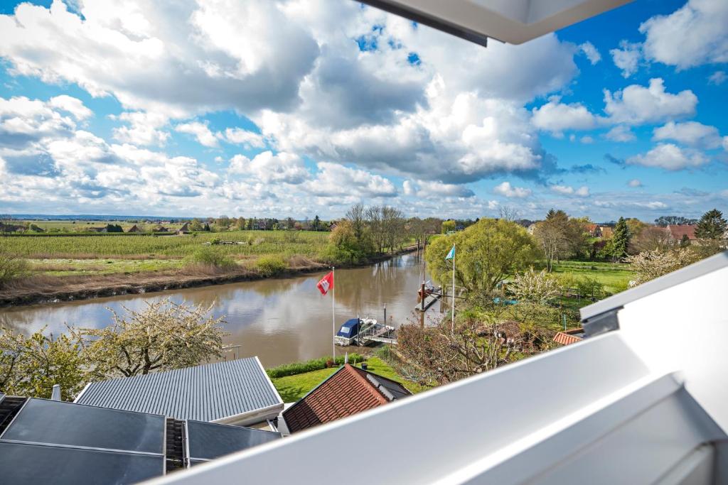 a view of a river from a balcony at Urlaub Hamburg Altes Land in Hamburg