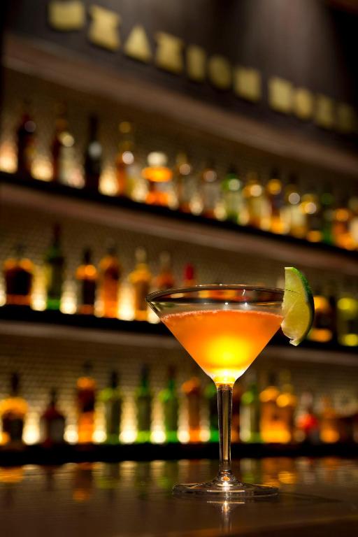 a drink in a martini glass sitting on a bar at The Tokyo Station Hotel in Tokyo