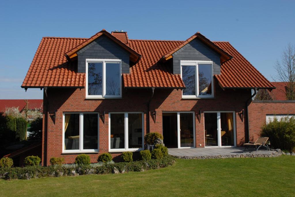 a brown brick house with a red roof at Wohlfühlapartment in Minden in Minden