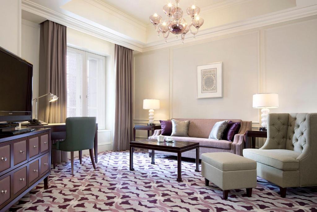 a living room with a couch and a tv at The Tokyo Station Hotel in Tokyo
