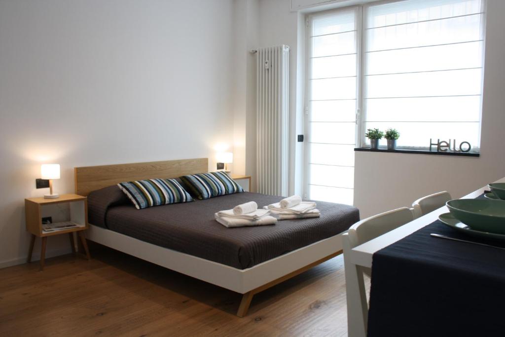 a bedroom with a bed with two towels on it at Milano Navigli Apartment - Via Tortona in Milan