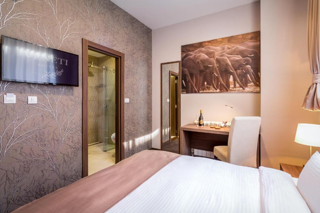 Postel nebo postele na pokoji v ubytování Veneti Suites