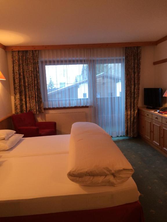 Postel nebo postele na pokoji v ubytování Hotel Garni Senn