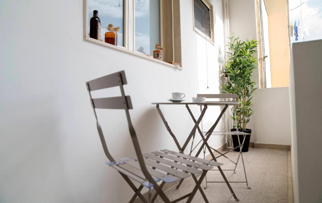 a chair sitting next to a table in a room at Room 56 in Bari