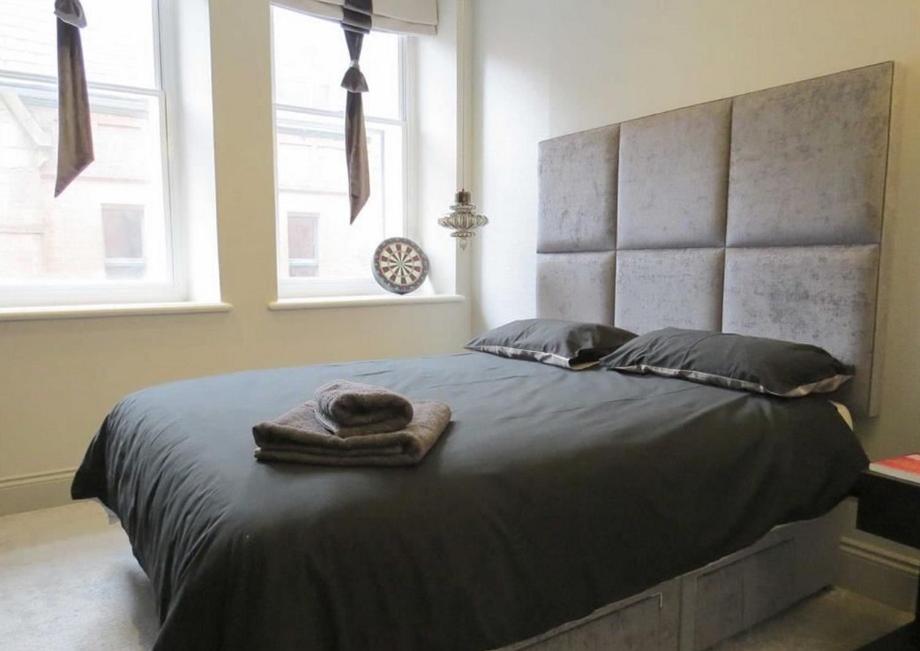 a bedroom with a bed with two towels on it at Trip & Hostel in Gdańsk
