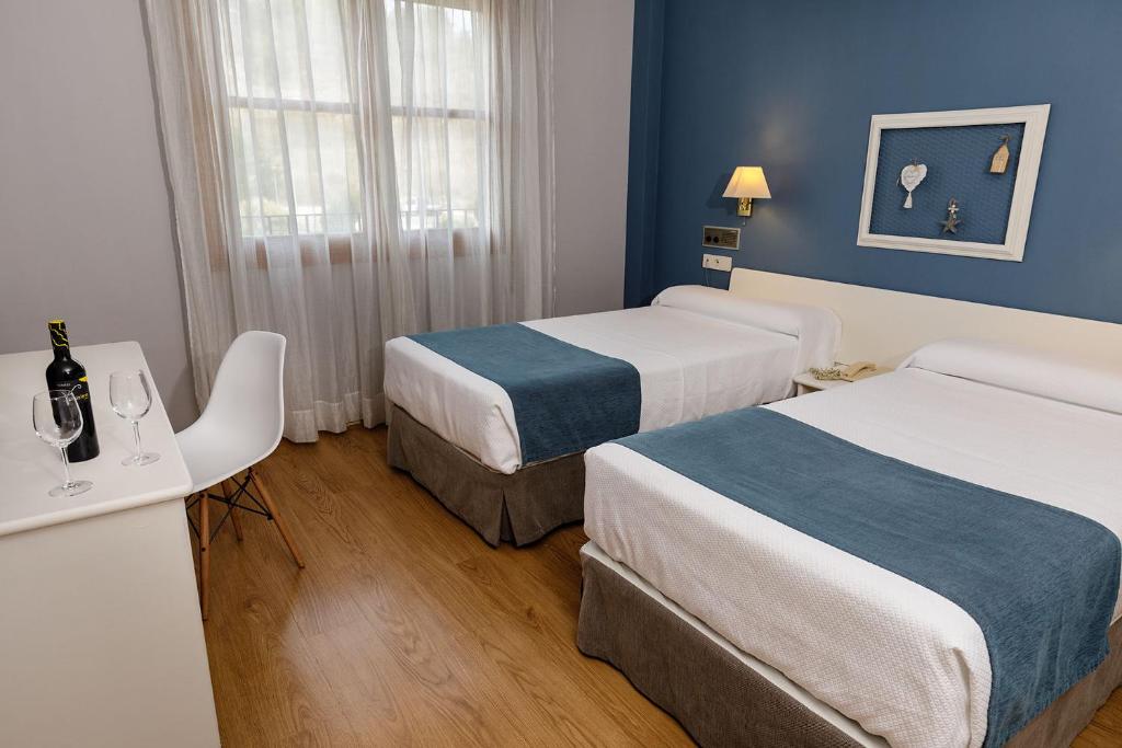 Postel nebo postele na pokoji v ubytování Hotel Jakue