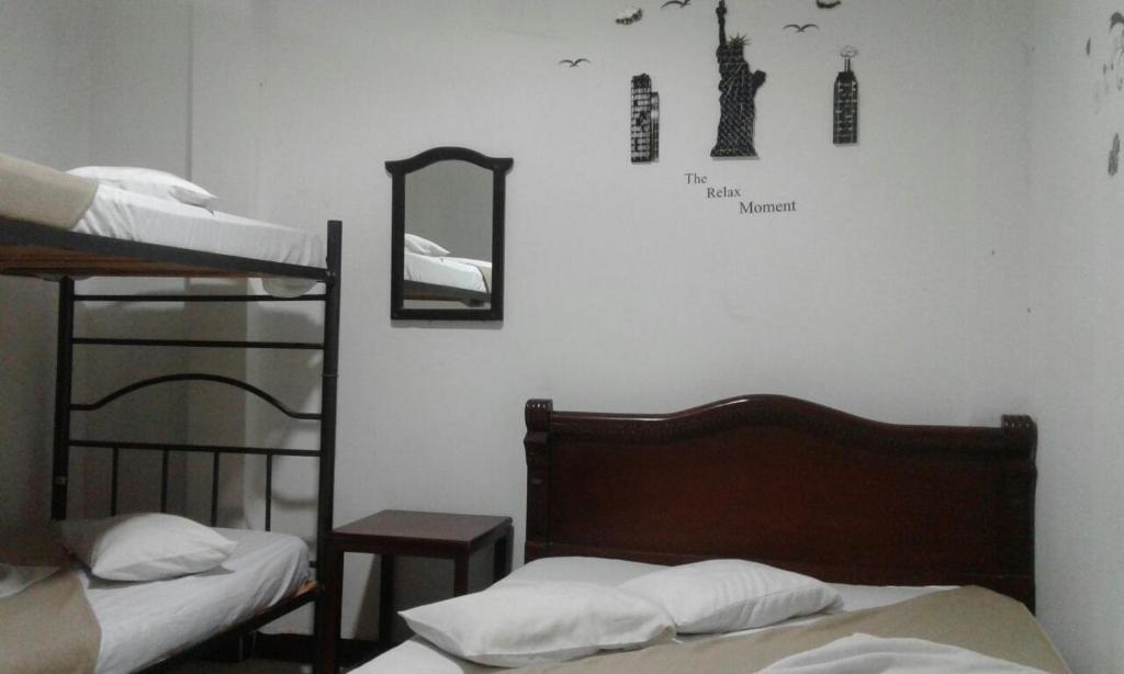 Ένα ή περισσότερα κρεβάτια σε δωμάτιο στο Hostal Balcony