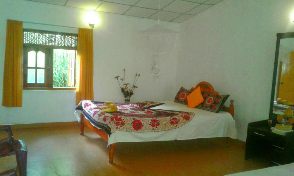 Postel nebo postele na pokoji v ubytování River Retreat Sigiriya