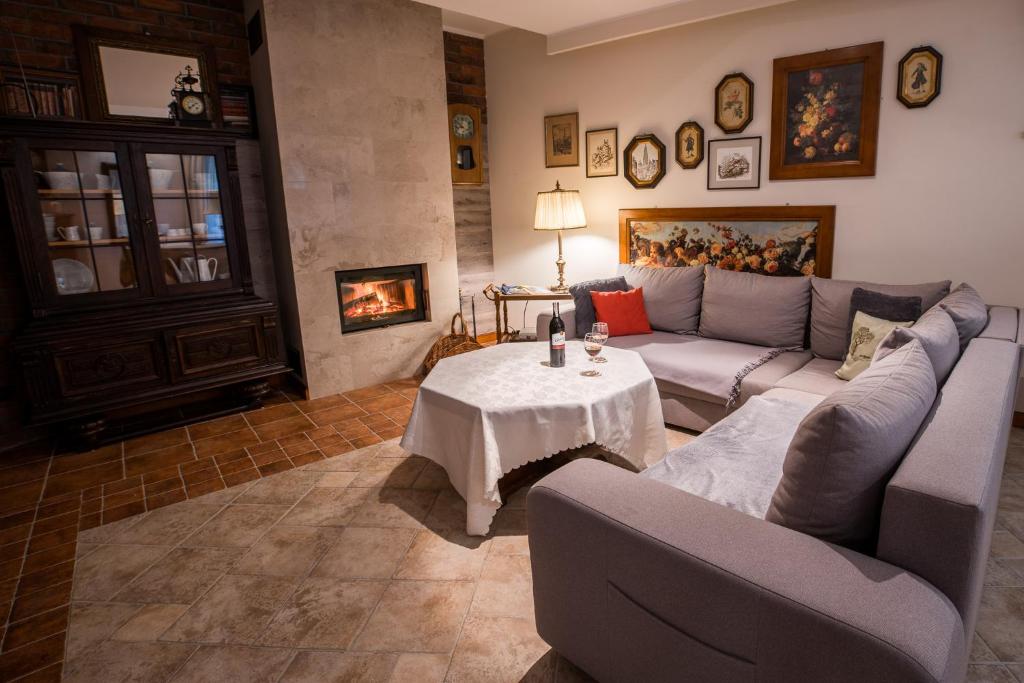 a living room with a couch and a table at Apartament Perła Kartuz z sauną in Kartuzy