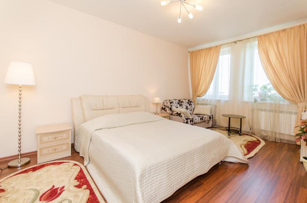 ニジニ・ノヴゴロドにあるСутки-Дом - Белинкаの白いベッドルーム(ベッド1台、椅子付)