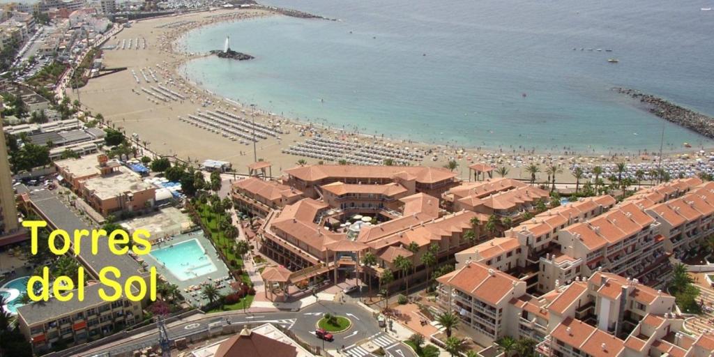 a view of a beach with buildings and the ocean at TORRES DEL SOL to 50 METTERS PLAYA LAS VISTAS Best beach Tenerife in Playa de las Americas