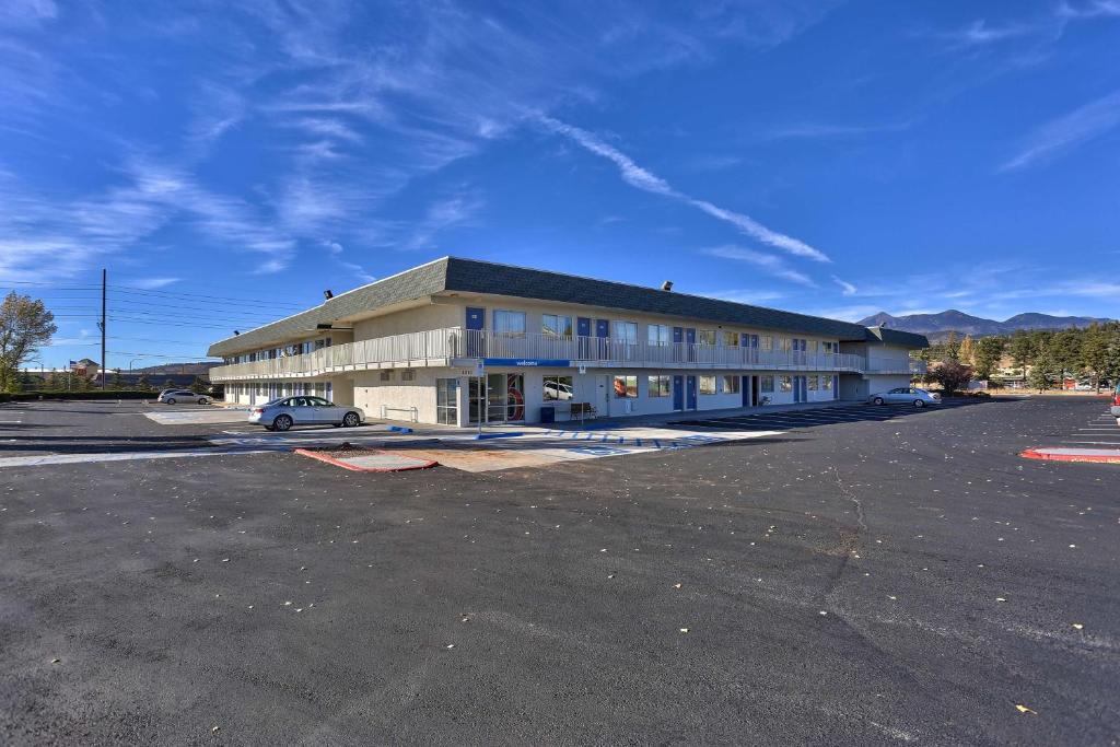 a large building with a car parked in a parking lot at Motel 6-Flagstaff, AZ - Butler in Flagstaff