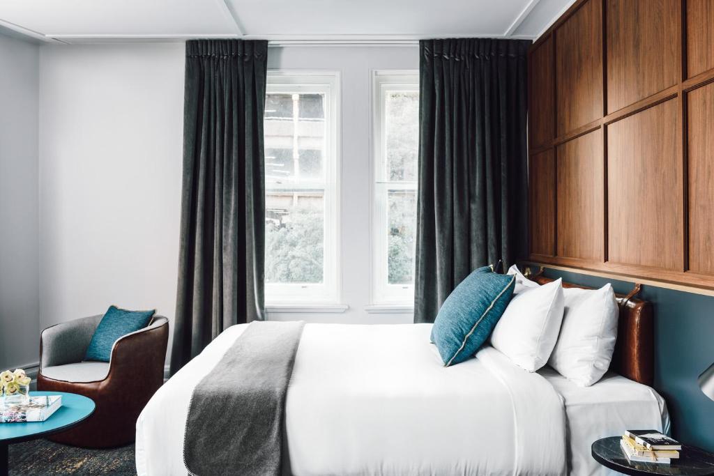a bedroom with a large bed and a large window at Veriu Central in Sydney