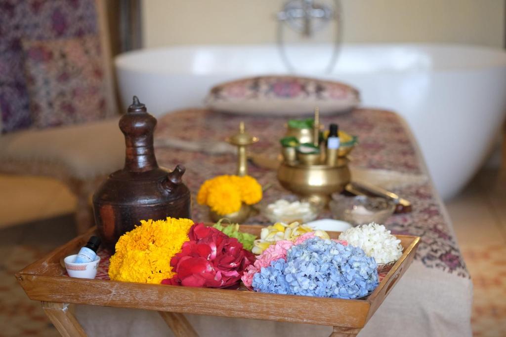 a table with flowers on top of a table at Amnaya Resort Kuta in Kuta