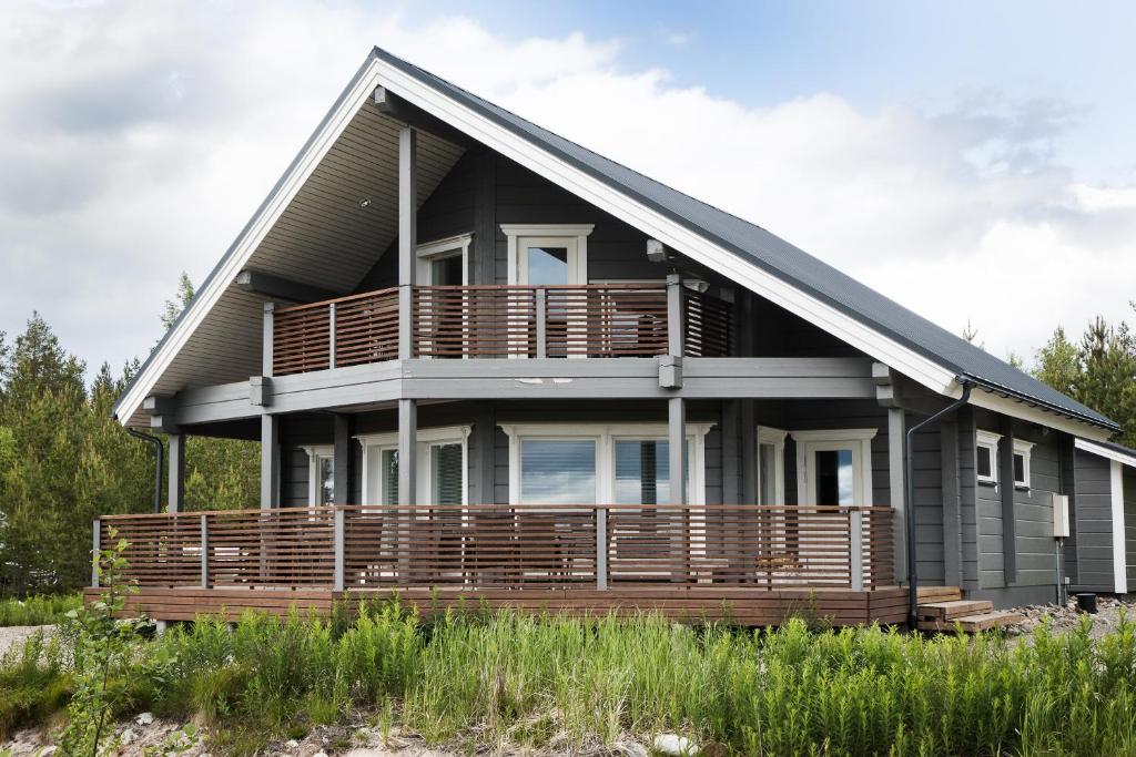 a house with a large deck on the side of it at Villa APR in Kurikka