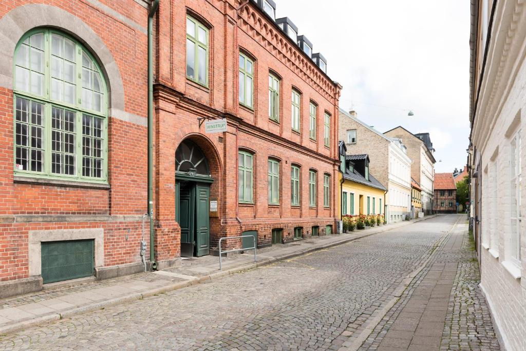 a brick building with a clock on the side of it at Winstrup Hostel in Lund