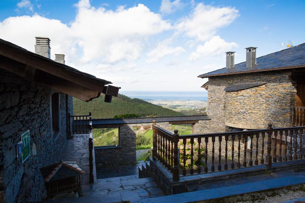 a balcony of a house with a view of the ocean at El Vallín de Alba in La Artosa