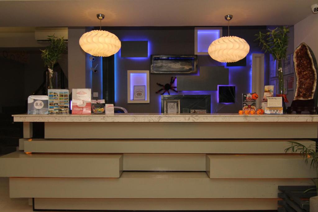 a bar with three pendant lights above a counter at Eloisa Royal Suites in Mactan