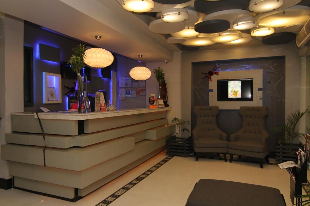 a bar with two chairs and a counter in a room at Eloisa Royal Suites in Mactan