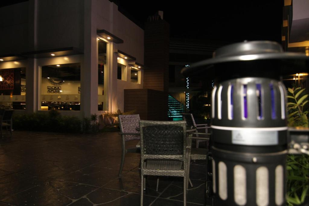 a trash can sitting on a patio at night at Eloisa Royal Suites in Mactan