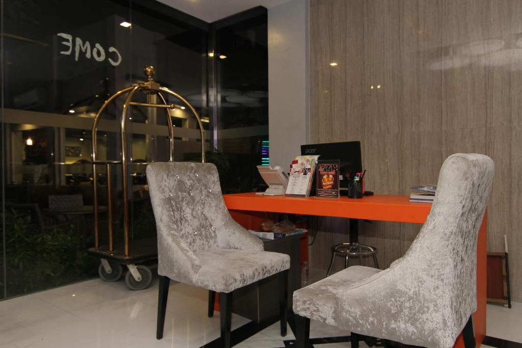 two chairs in front of a desk in a store at Eloisa Royal Suites in Mactan