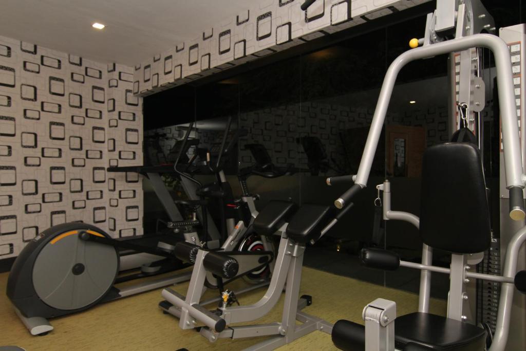 a gym with cardio equipment in a room at Eloisa Royal Suites in Mactan