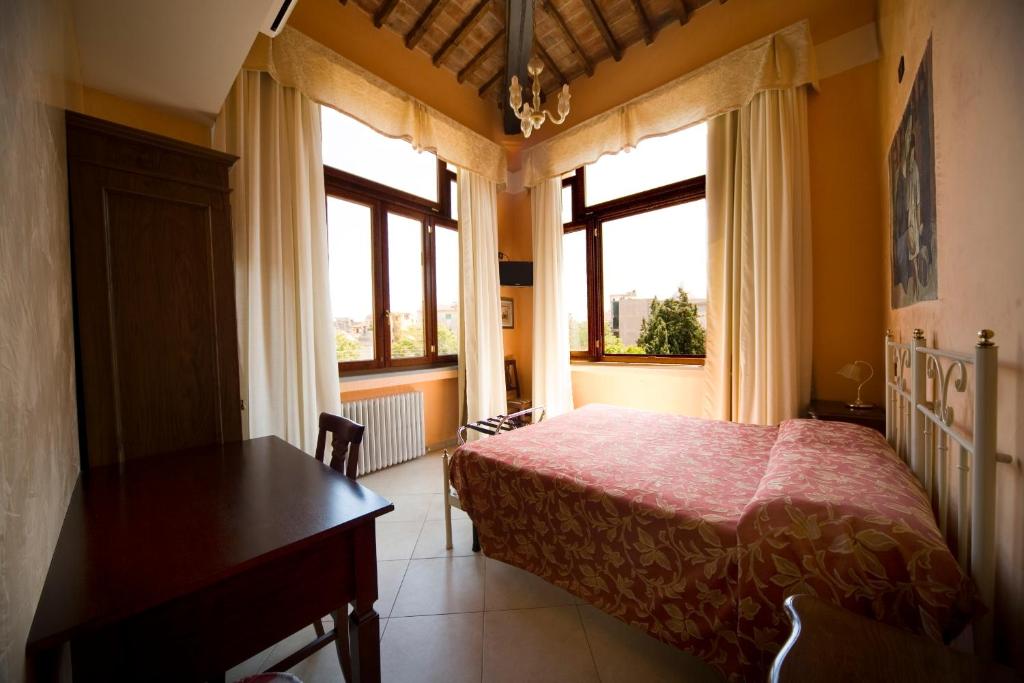 Postel nebo postele na pokoji v ubytování Hotel Merlini