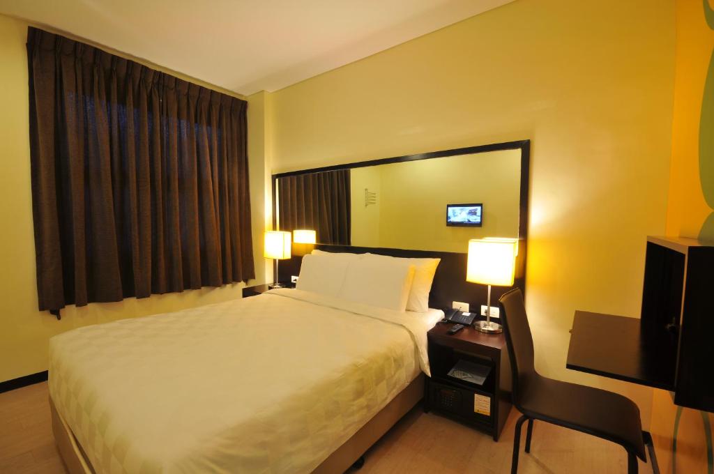 Postel nebo postele na pokoji v ubytování Go Hotels Puerto Princesa