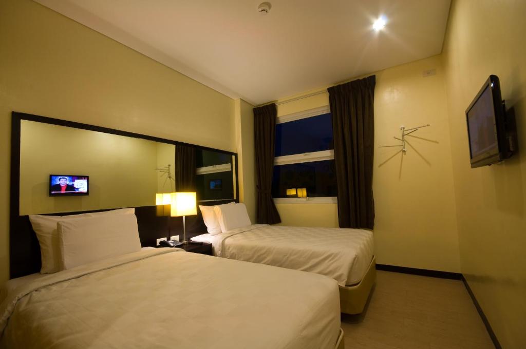 Postel nebo postele na pokoji v ubytování Go Hotels Puerto Princesa