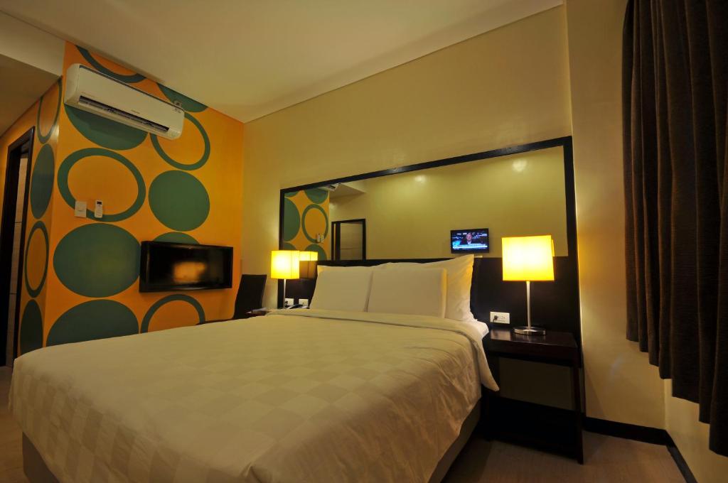 Postel nebo postele na pokoji v ubytování Go Hotels Puerto Princesa