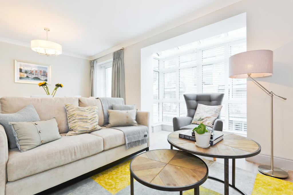 a living room with a couch and a table at Exclusive City Centre Apartment in Dublin