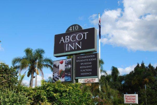 a sign for a abbot inn on a street at Abcot Inn in Sylvania