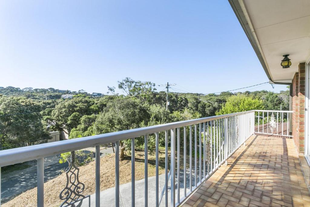 a balcony with a view of the water at Tyrone Beach House in Rye
