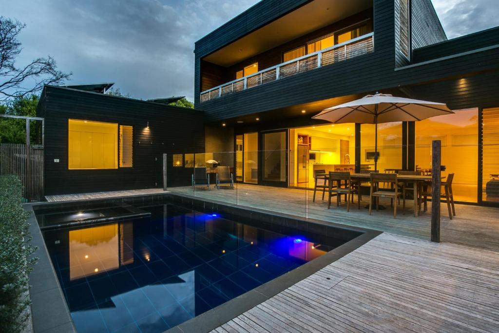 uma casa com piscina em frente a uma casa em C-Escape em Blairgowrie