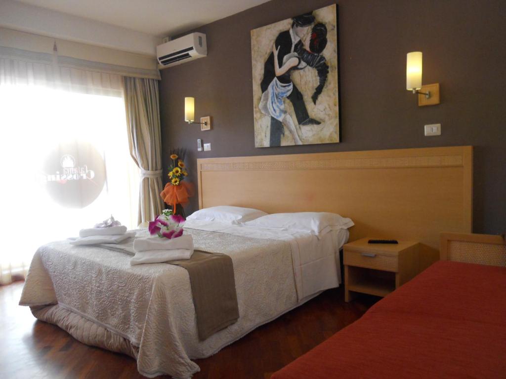 a hotel room with a bed with towels on it at Catania Crossing B&B - Rooms & Comforts in Catania