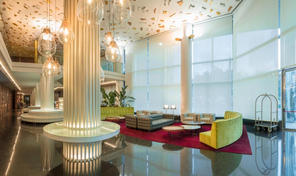 a lobby with couches and chairs in a building at SH Valencia Palace in Valencia