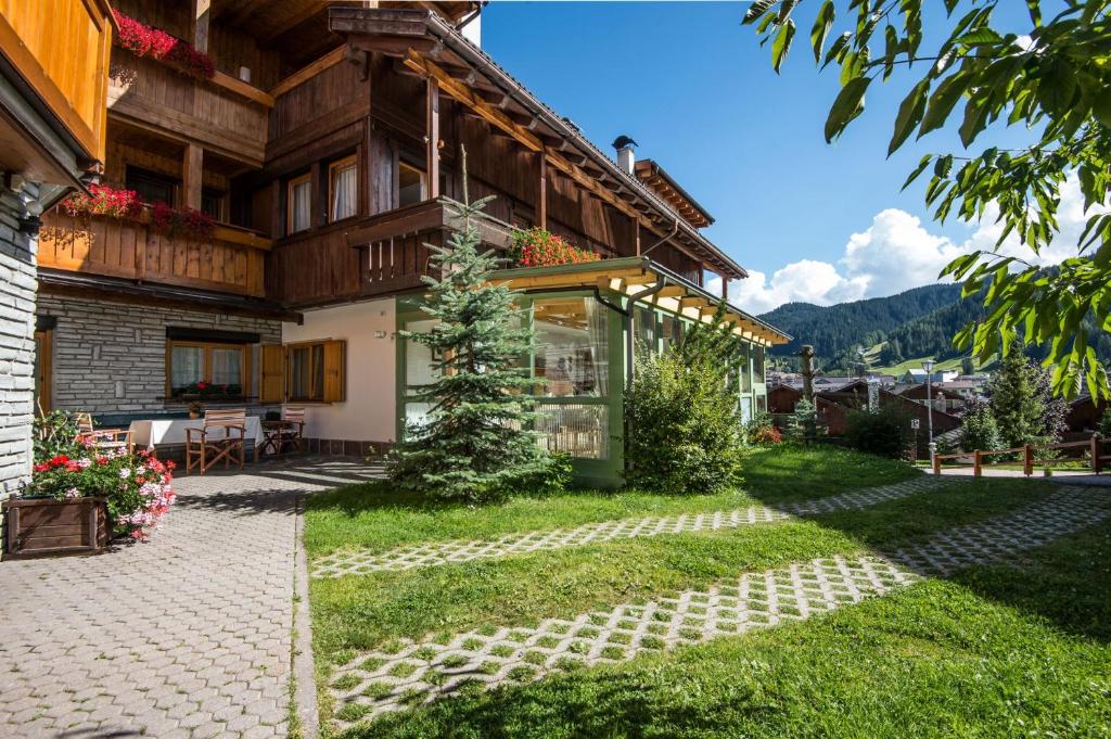 a house in the mountains with a patio at Ciasa Confolia in Corvara in Badia