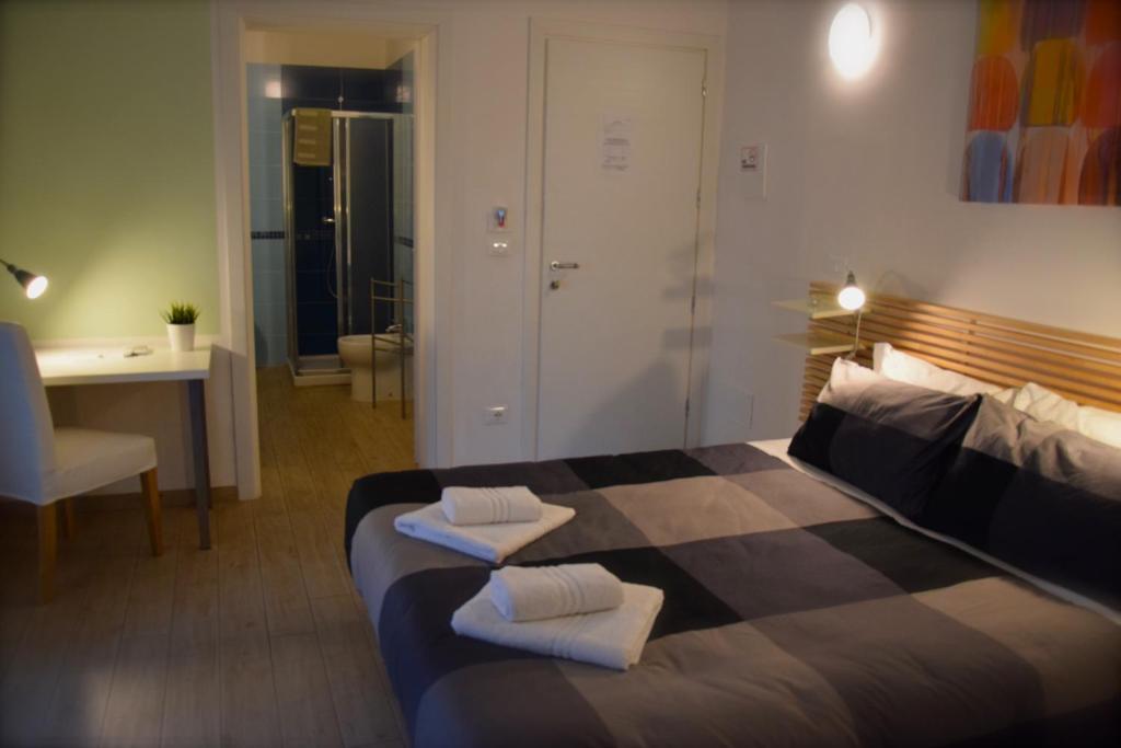 a bedroom with a bed with two towels on it at My Bnb Pisa in Pisa