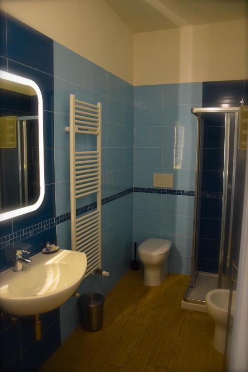 a blue bathroom with a sink and a toilet at My Bnb Pisa in Pisa