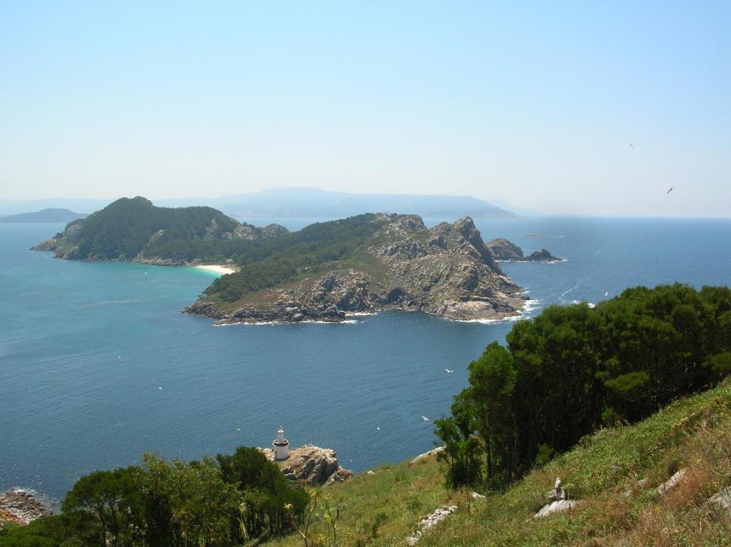 a view of a large body of water with a lighthouse at Apartment Plaza Fernando in Vigo