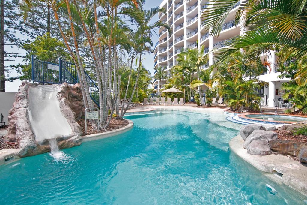 a swimming pool with a water slide in a resort at Ramada Resort by Wyndham Golden Beach in Caloundra